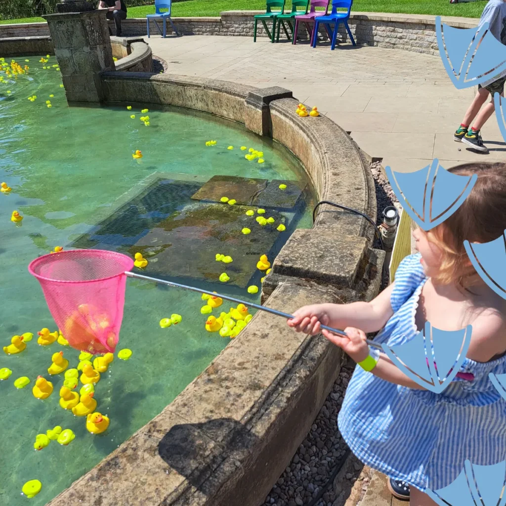 little girl at thornbridge hall and gardens in the plastic duck fountain