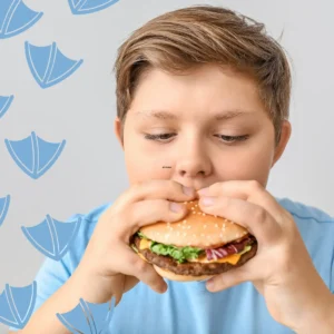 Where Kids Can Eat for Free In Derbyshire Summer Holidays with boy eating burger against a blue background
