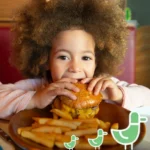 kid eating a free burger for school holiday meal where kids eat free