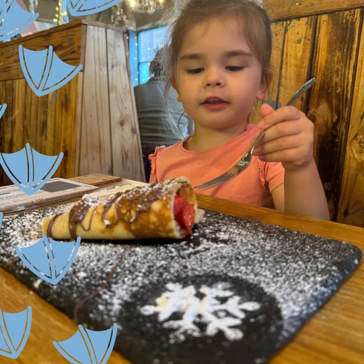 little girl eating a chocolate pancake at quoozies chesterfield
