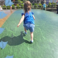 little girl on balloon pad in matlock park farm derbyshire