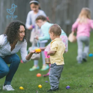 kids playing easter egg hunt in derbyshire with a mum passing an egg to a young child