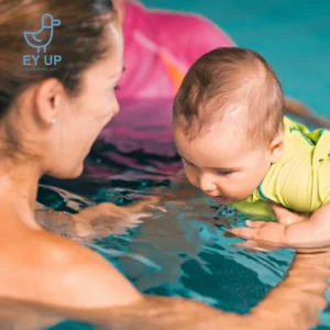 baby in a baby swim class with mum holding her in the water