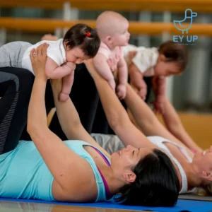 mums and babys at a baby class in chesterfield. Babies being lifted in the air by mums